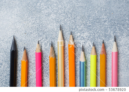 Bright colored pencils on the grey table. concept Bright colored pencils on the grey table. concept 53678920