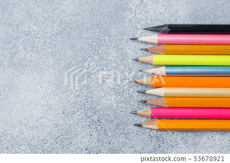 Bright colored pencils on the grey table. concept Bright colored pencils on the grey table. concept 53678921