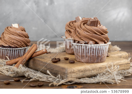 brown cupcakes with cocoa cream, cinnamon and 53678999