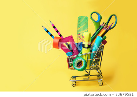 Back to school concept with shopping cart and colorful pencils, square ruler, scissors, clips, 53679581
