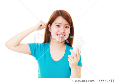 A smiling woman with a smartphone A smiling woman with a smartphone 53679711