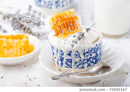 Ice cream with honey and lavender in bowls. White background. Ice cream with honey and lavender in bowls. White background. 53680167