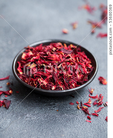 Hibiscus tea in black bowl. Slate background. Copy space. 53680369