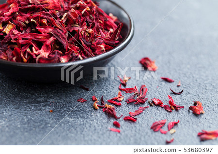 Hibiscus tea in black bowl. Slate background. Close up. Copy space. 53680397