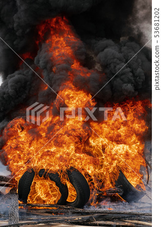 Burning cars wheels, flame of red-orange fire Burning cars wheels, flame of red-orange fire 53681202
