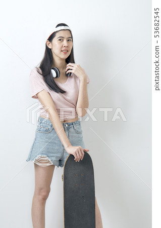 Beautiful asian girl holding skateboard 53682545