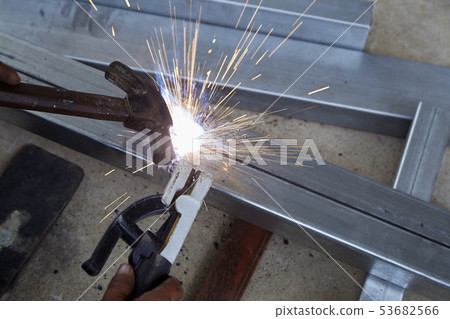 The welders are welding steel in the factory 53682566