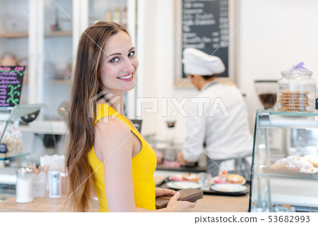 Woman in the pastry shop choosing sweet desserts Woman in the pastry shop choosing sweet desserts 53682993