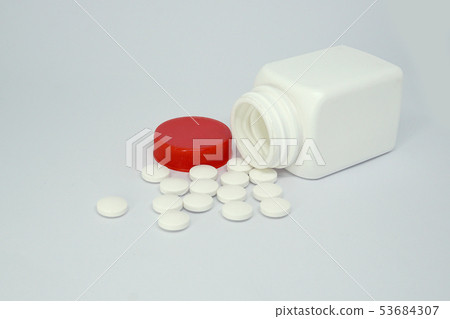 Medicine bottle and pills isolated on white Medicine bottle and pills isolated on white 53684307