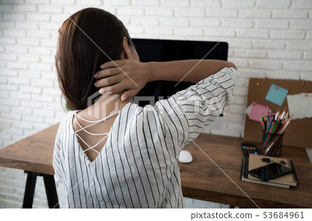 business woman suffering from pain in neck working 53684961