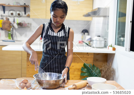 Girls mixing dough, making cookies in the kitchen 53685020