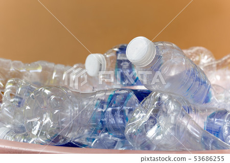 Recyclable garbage of glass plastic bottles in rubbish bin. 53686255