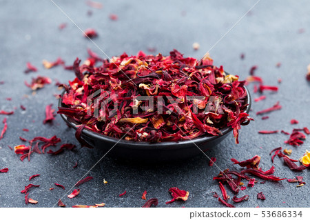 Hibiscus tea in black bowl. Slate background. Copy space. Hibiscus tea in black bowl. Slate background. Copy space. 53686334