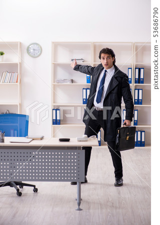 Young male employee in the office in time management concept Young male employee in the office in time management concept 53686790