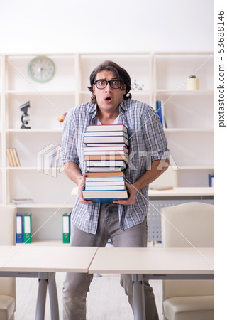 Young male student preparing for exams at home  53688146