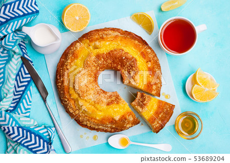 Lemon bundt cake with cup of tea. Blue background. Top view. 53689204