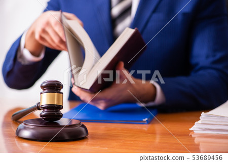 Young male judge sitting in courtroom  53689456