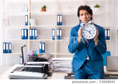 Young employee making copies at copying machine  53689691