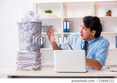 Businessman rejecting new ideas with lots of papers 53690112