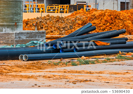 Plastic water pipes lying on the construction site 53690430