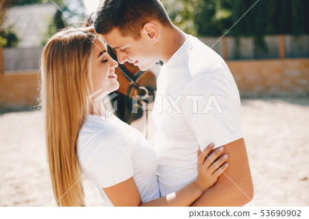 Beautiful couple spend time with a horses Beautiful couple spend time with a horses 53690902