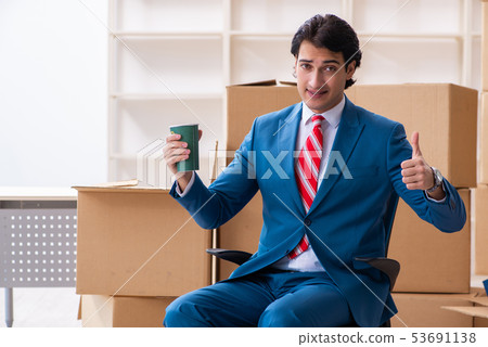 Young handsome businessman moving to new workplace  53691138