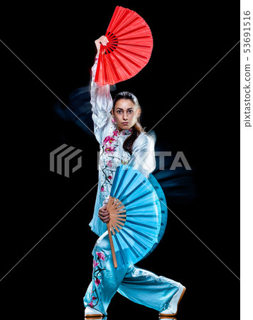 woman Tai Chi Chuan Tadjiquan posture isolated black background light painting woman Tai Chi Chuan Tadjiquan posture isolated black background light painting 53691516