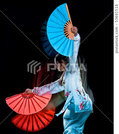 woman Tai Chi Chuan Tadjiquan posture isolated black background light painting  53691518