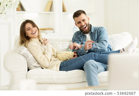 Young Couple Laughing Watching Comedy Movie Online Young Couple Laughing Watching Comedy Movie Online 53692007