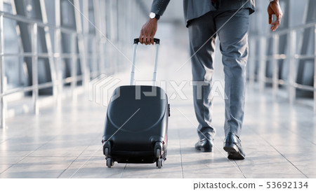 Businessman At Airport Moving To Terminal Gate For Business Trip Businessman At Airport Moving To Terminal Gate For Business Trip 53692134