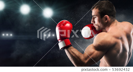 Healthy athlete man showing his hand muscles on camera Healthy athlete man showing his hand muscles on camera 53692432