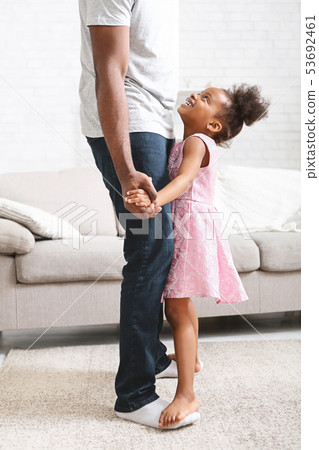 Little african american girl dancing with father 53692461