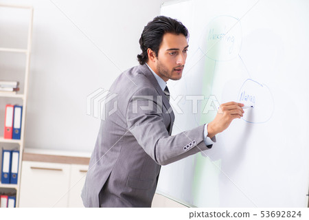 Young handsome businessman in front of whiteboard  53692824