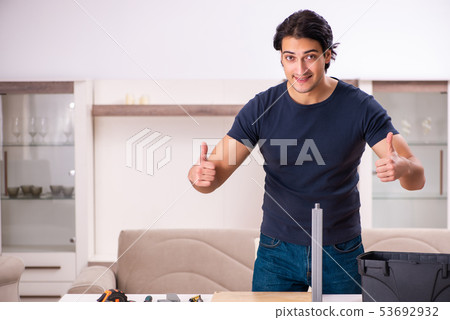 Young man repairing furniture at home Young man repairing furniture at home 53692932