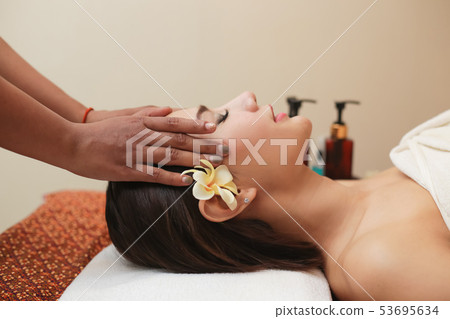 Young asian woman receiving head massage at beauty 53695634