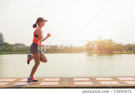 Young fitness woman running in the park. 53695671