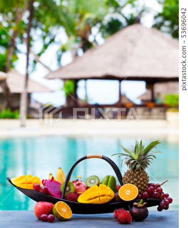 Tropical fruits assortment in wooden boat. Outdoor tropical background. Copy space. 53696042