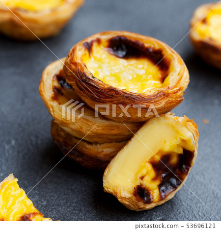 Egg tart, traditional Portuguese dessert, pastel de nata, pasteis. Slate background. Close up. 53696121