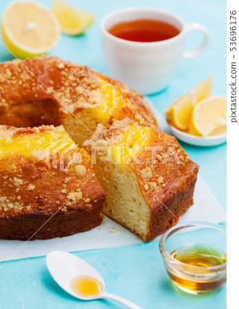 Lemon bundt cake with cup of tea. Blue background. Close up. 53696176