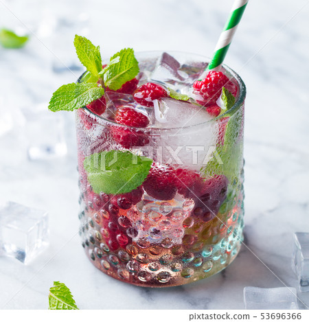 Raspberry cocktail, fizz, lemonade, ice tea with fresh mint on marble background. Close up. 53696366