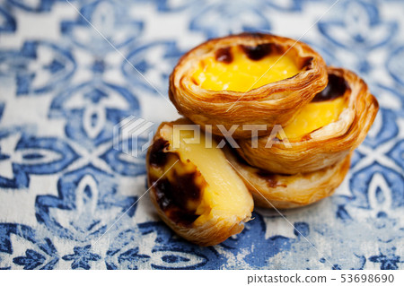 Egg tart, traditional Portuguese dessert, pastel de nata. Blue background. Close up. 53698690