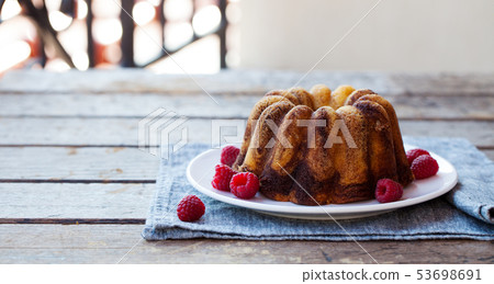 Chocolate marble bundt cake with raspberry on wooden background. Copy space. 53698691
