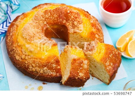 Lemon bundt cake with cup of tea. Blue background. Close up. 53698747