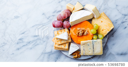 Assortment of cheese, grapes and crackers. Marble background. Top view. Copy space. 53698780