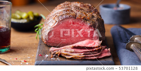 Roast beef on cutting board. Wooden background. Close up. 53701128