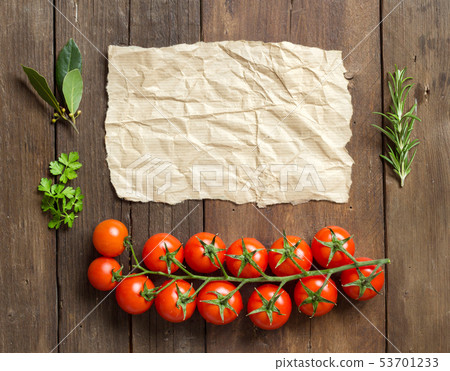 Cherry tomatoes, herbs and craft paper 53701233