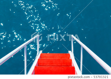 The red staircase with white railings goes into The red staircase with white railings goes into 53701321