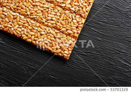 Tile kozinaki from sunflower seeds on a black Tile kozinaki from sunflower seeds on a black 53701329