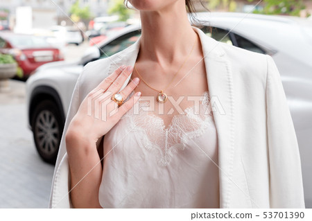 People, fashion, jewelry and luxury concept, closeup of woman wearing luxury jewelry standing near 53701390