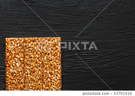 Tile kozinaki from sunflower seeds on a black Tile kozinaki from sunflower seeds on a black 53701418